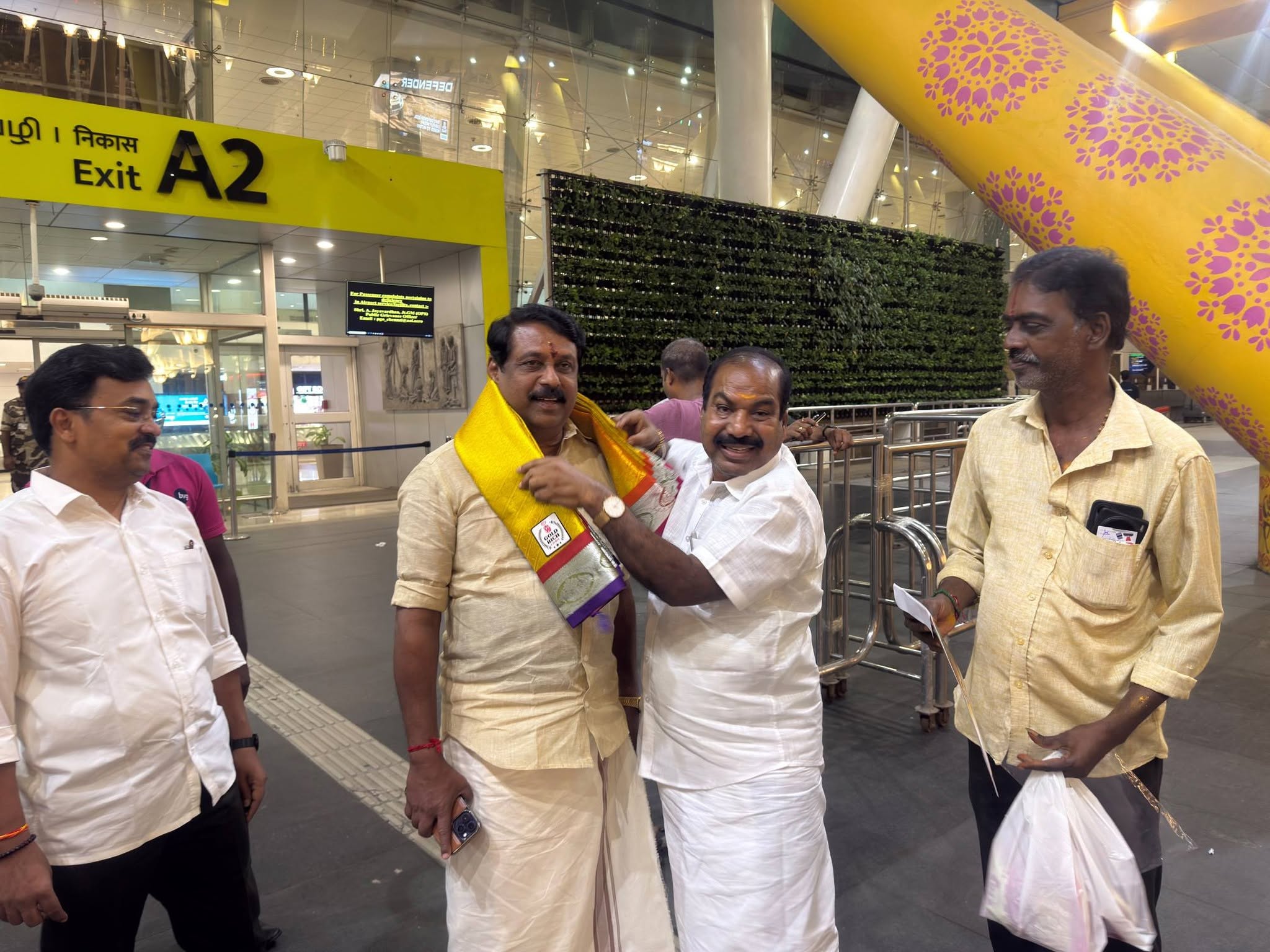Kalidass welcomes a visiting party leader on arrival in Chennai, garlanding him as part of the reception party.