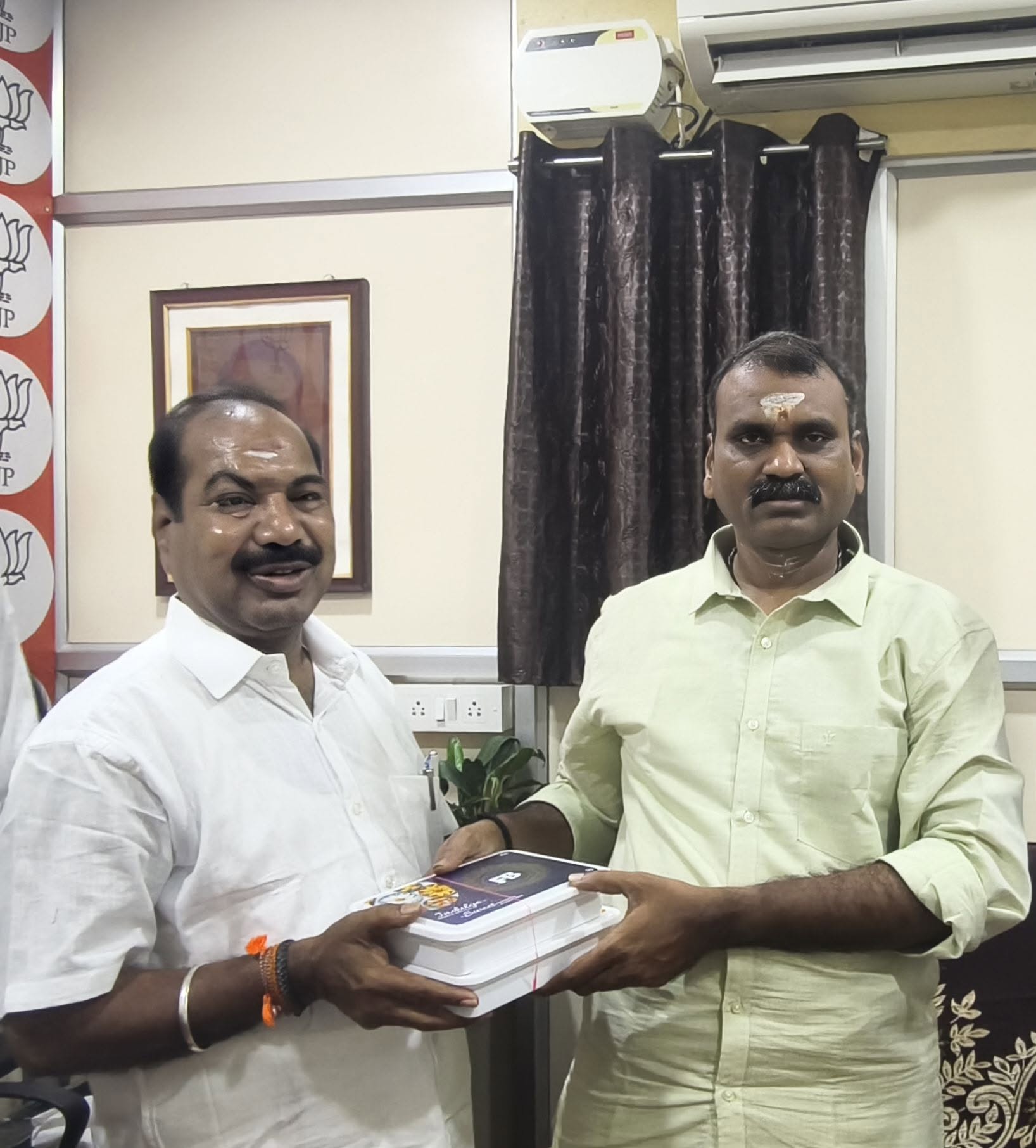 Exchanging festive greetings with a fellow party functionary at the local BJP office.