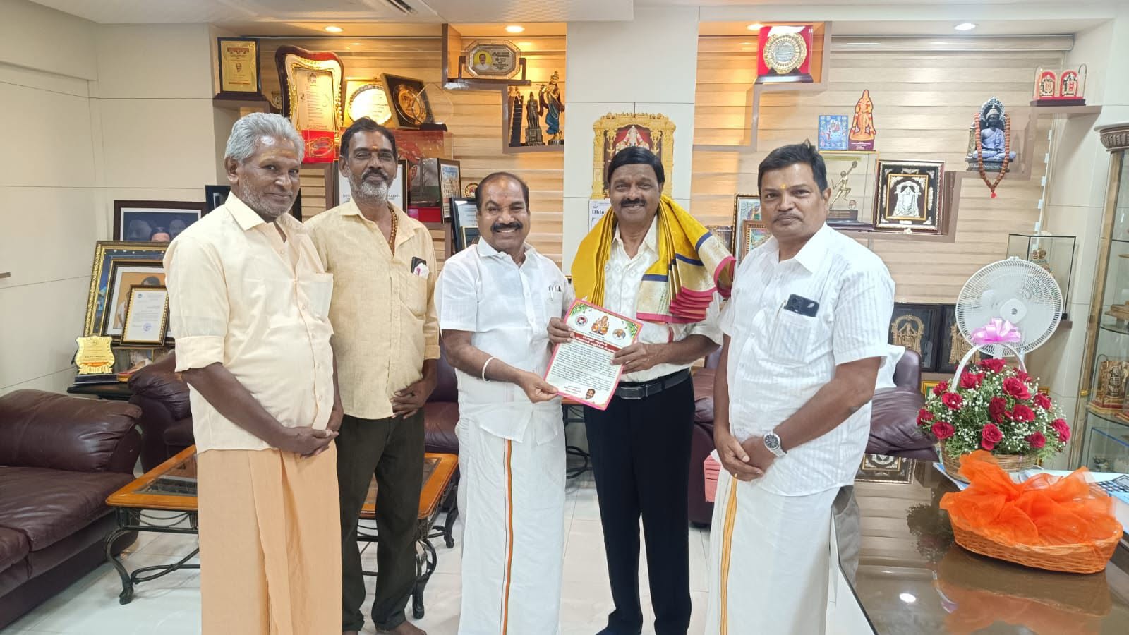 Presenting a citation to a senior figure, marking his contribution to the community.